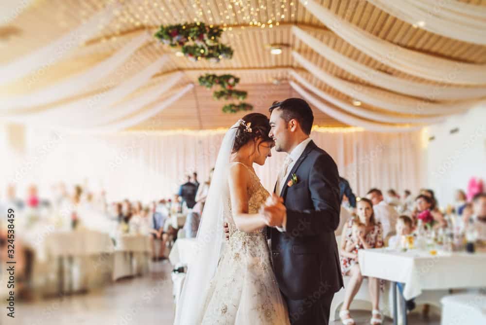 Happy just married young couple at the first wedding dance