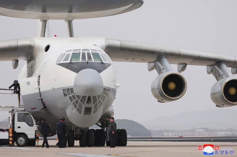 Kim Jong-un boards North Korean airborne warning plane published by KCNA
