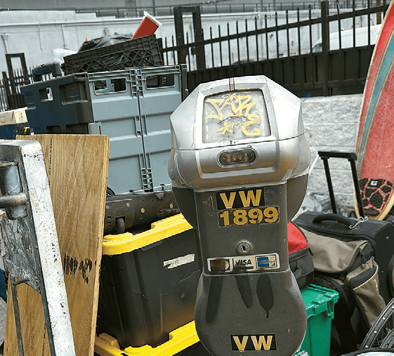 Damaged LA parking meter on New Hampshire Avenue blocked by tent in Koreatown