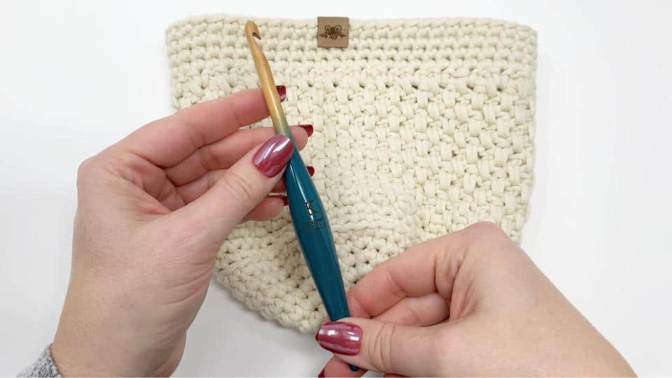 photo showing a teal colour wooden furls crochet hook