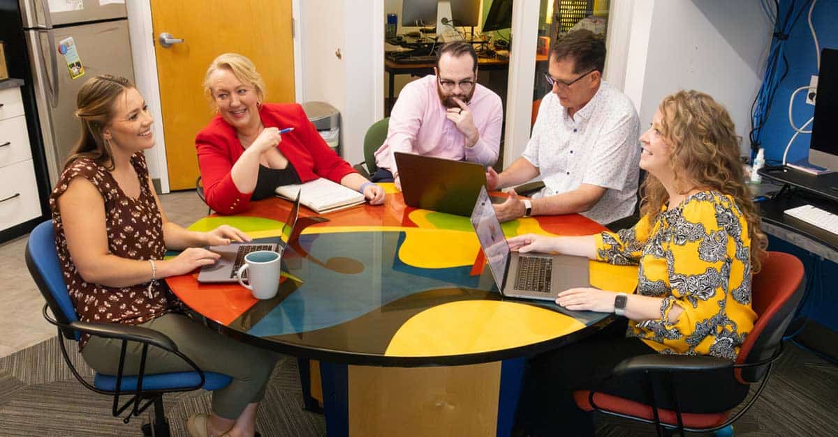 The-Creative-Company-2025-Team-Photo-Meeting-Around-the-Table-1200x627