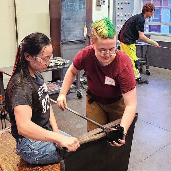 Hot glass instructor with student at Pittsburgh Glass Center