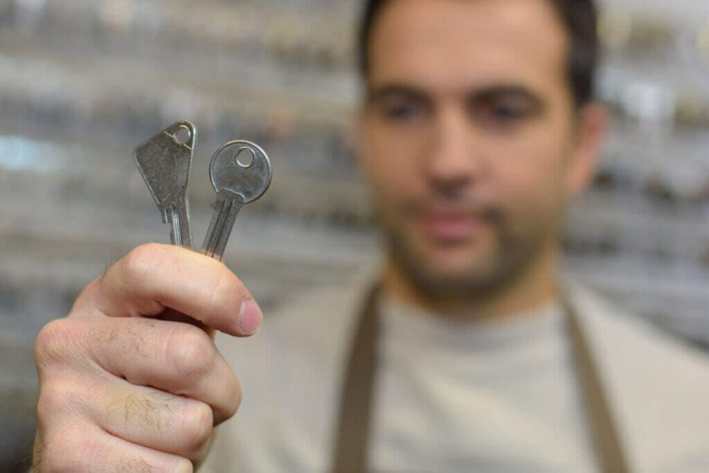 A person holding two keys