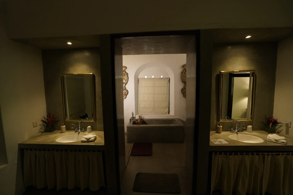 A luxurious bathroom in the Peacock Royal room featuring an elegant sink and a classic tub.