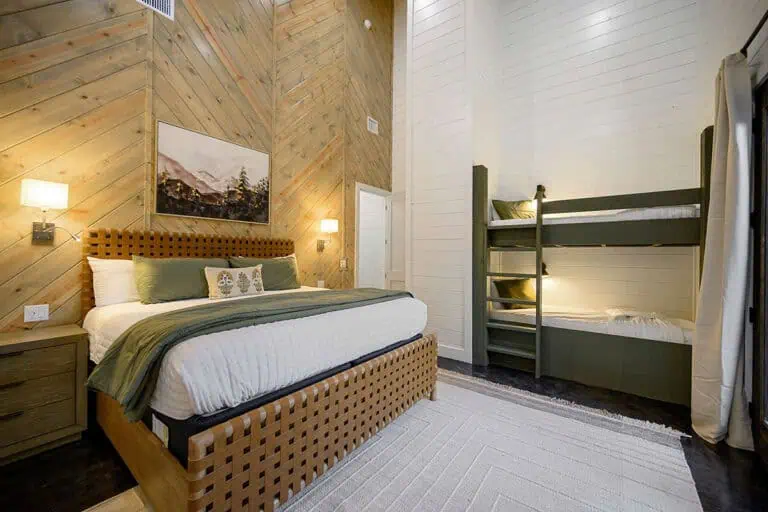 Master bedroom in broken bow luxury cabin with king-size bed and elegant décor.