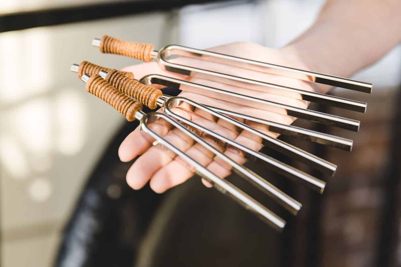 woman holding tuning forks in her hand