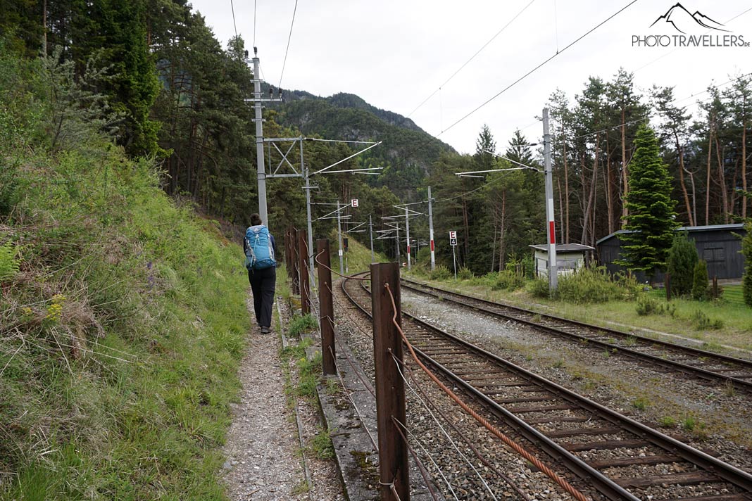 Reisebloggerin Biggi Bauer wandert auf einem schmalen Pfad neben den Bahngleisen