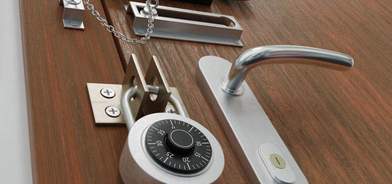 A wooden door with various security mechanisms, including a door handle, deadbolt lock, combination lock, chain lock, latch lock, and padlock. The door appears heavily secured with multiple layers of locking devices that would impress any locksmith.