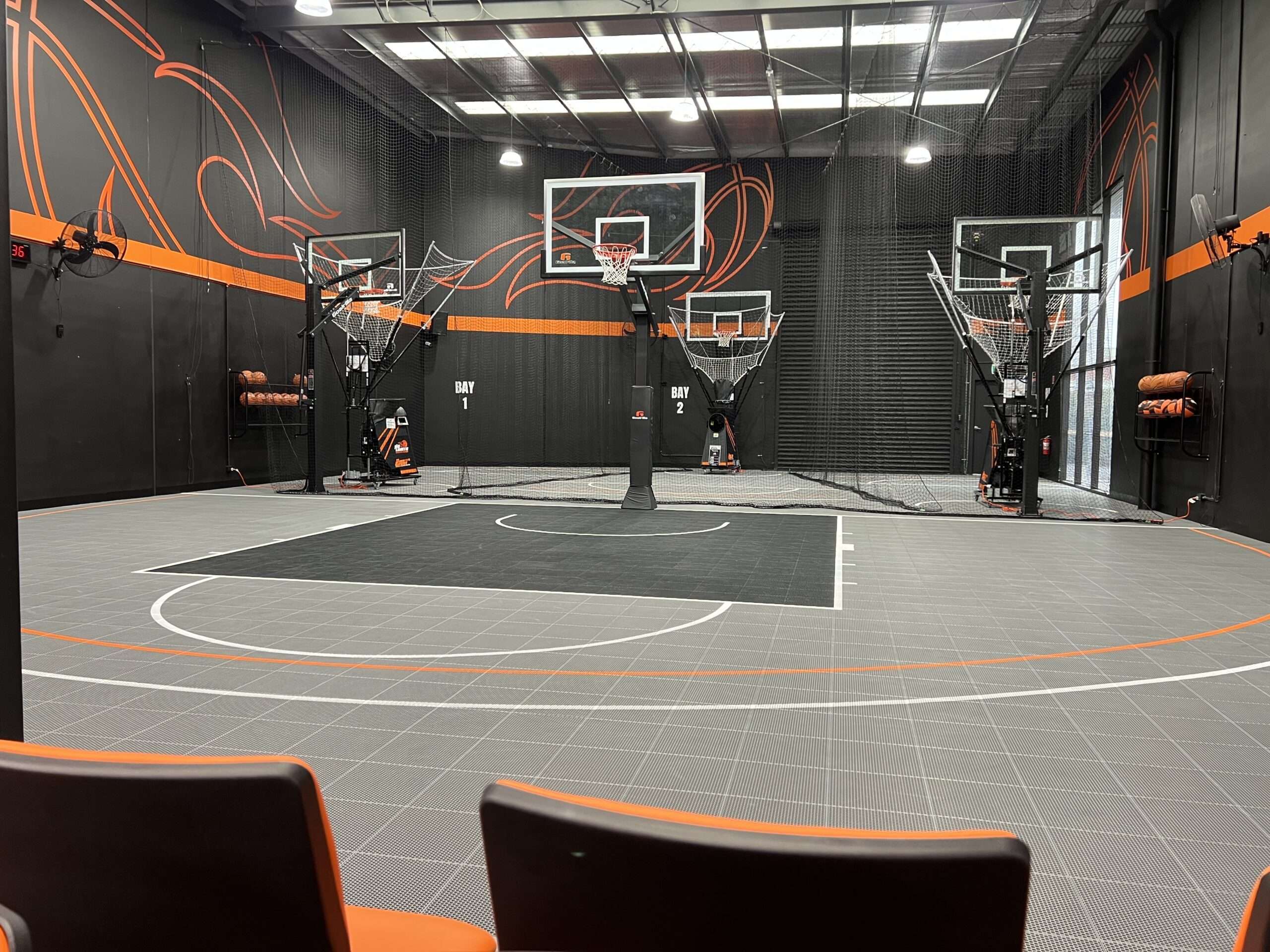 Basketball training court with multiple hoops and safety nets at No Limits Basketball.