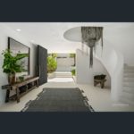 A room filled with furniture and vase of flowers on a table