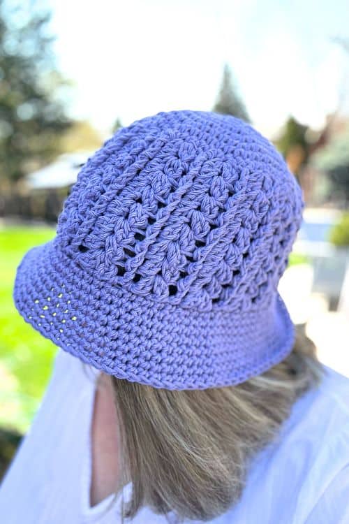 person wearing a purple crochet bucket hat