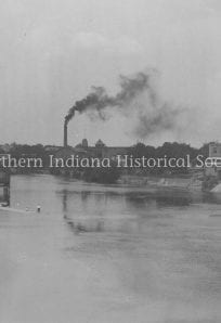 West Race - Birdsell ph1802 (1) Industrial town with factories and smokestacks along a river in a historic black and white photograph.