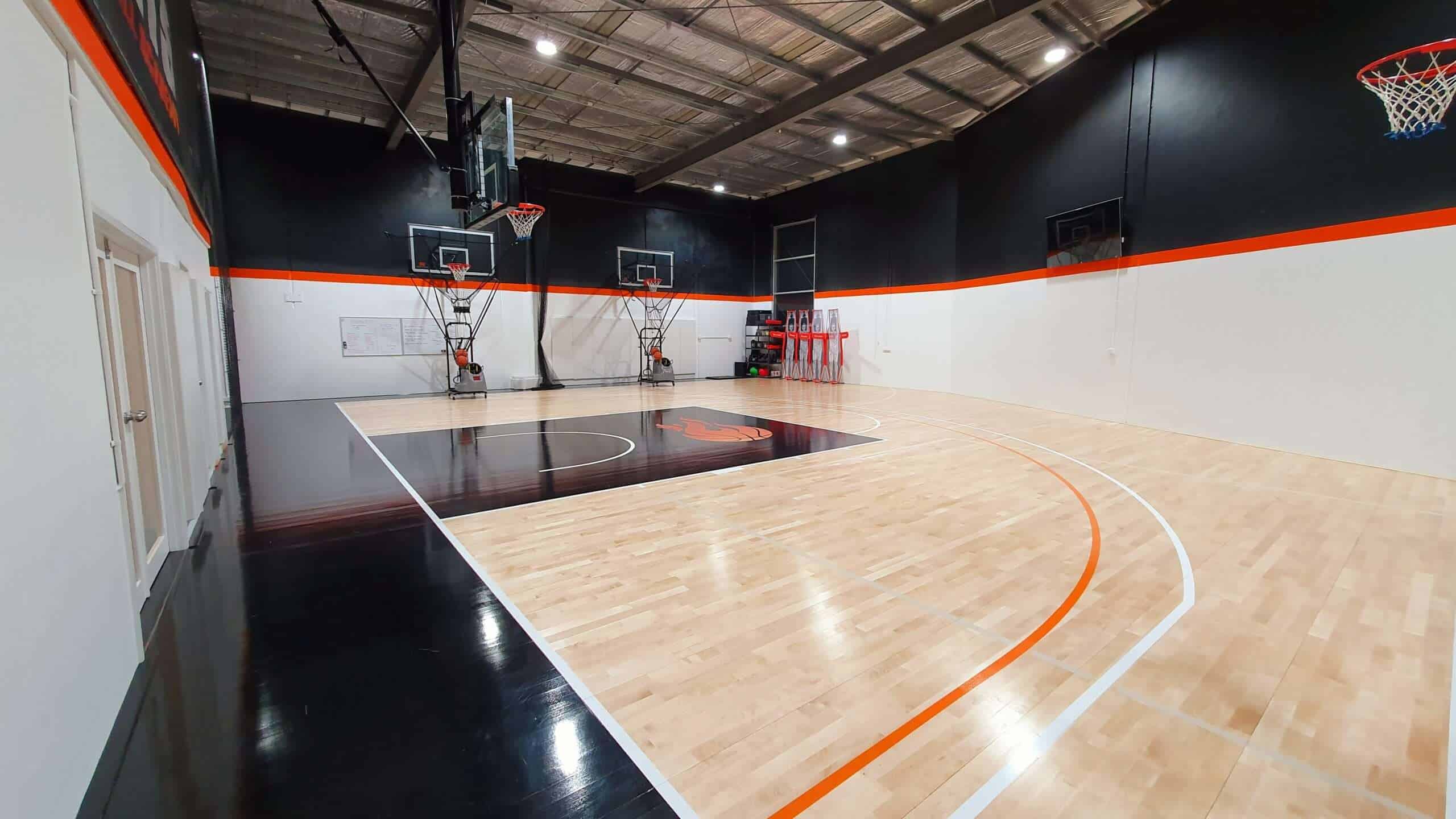 Indoor basketball court with professional hoops and wooden flooring at No Limits Basketball, perfect for training and games.
