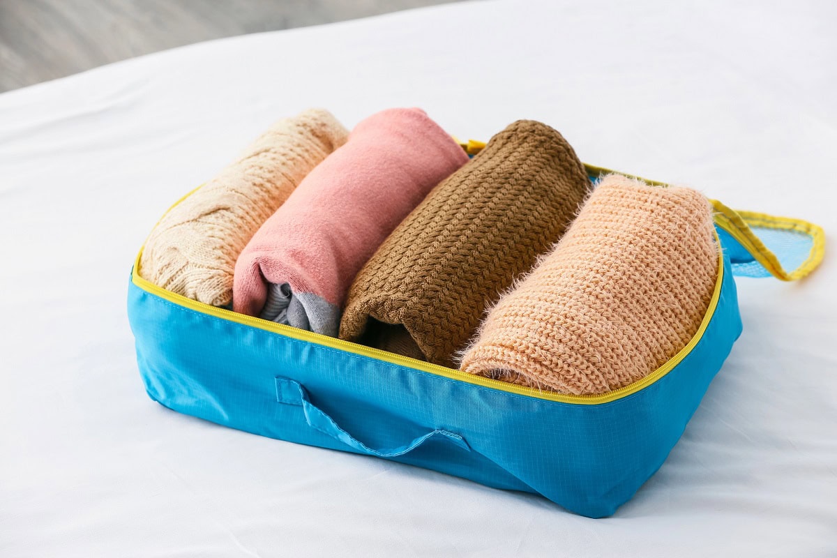how to pack sweaters in a suitcase