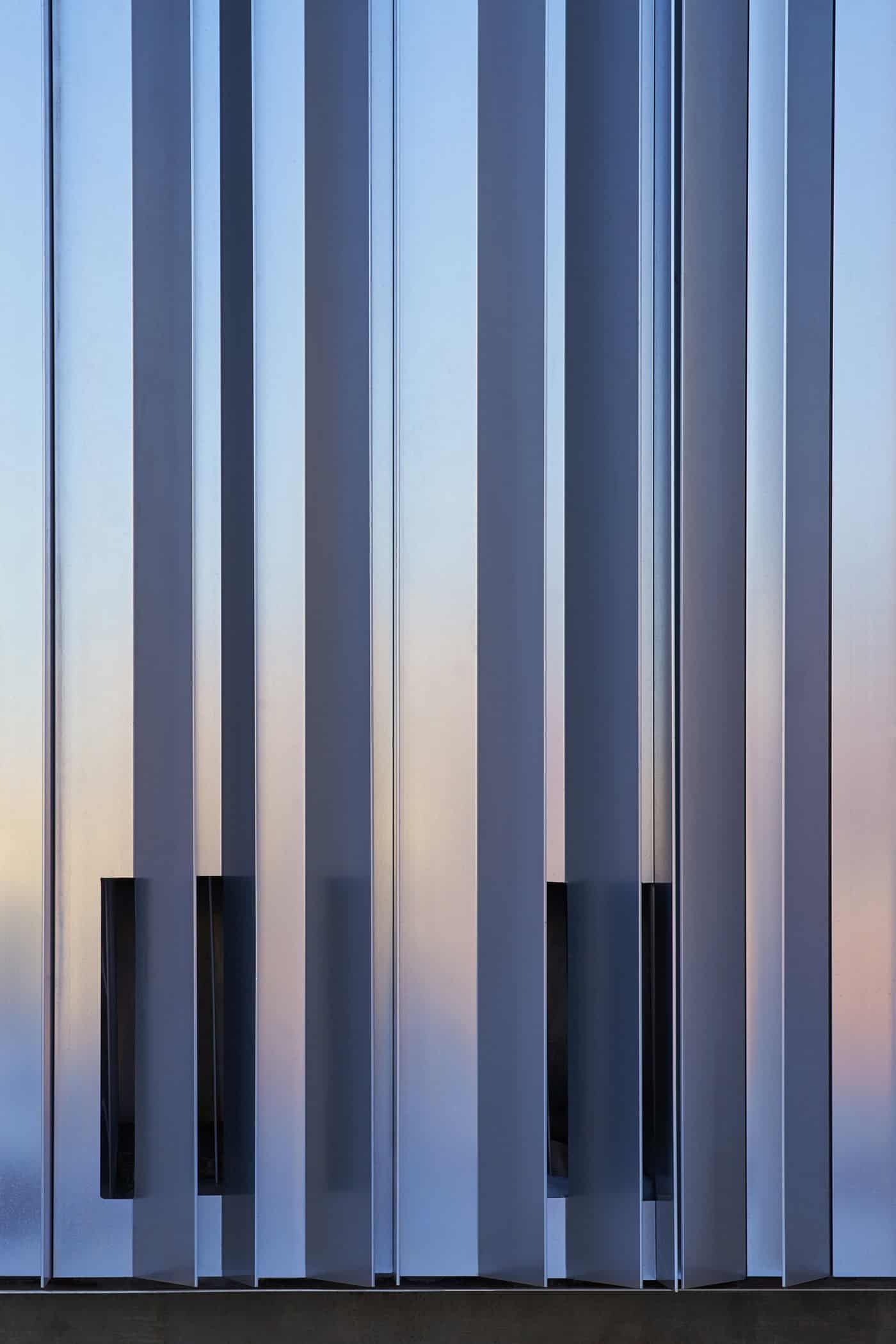 Close-up view of the Oklahoma Contemporary Arts Center’s exterior aluminum fins, capturing light and shadow at sunset.
