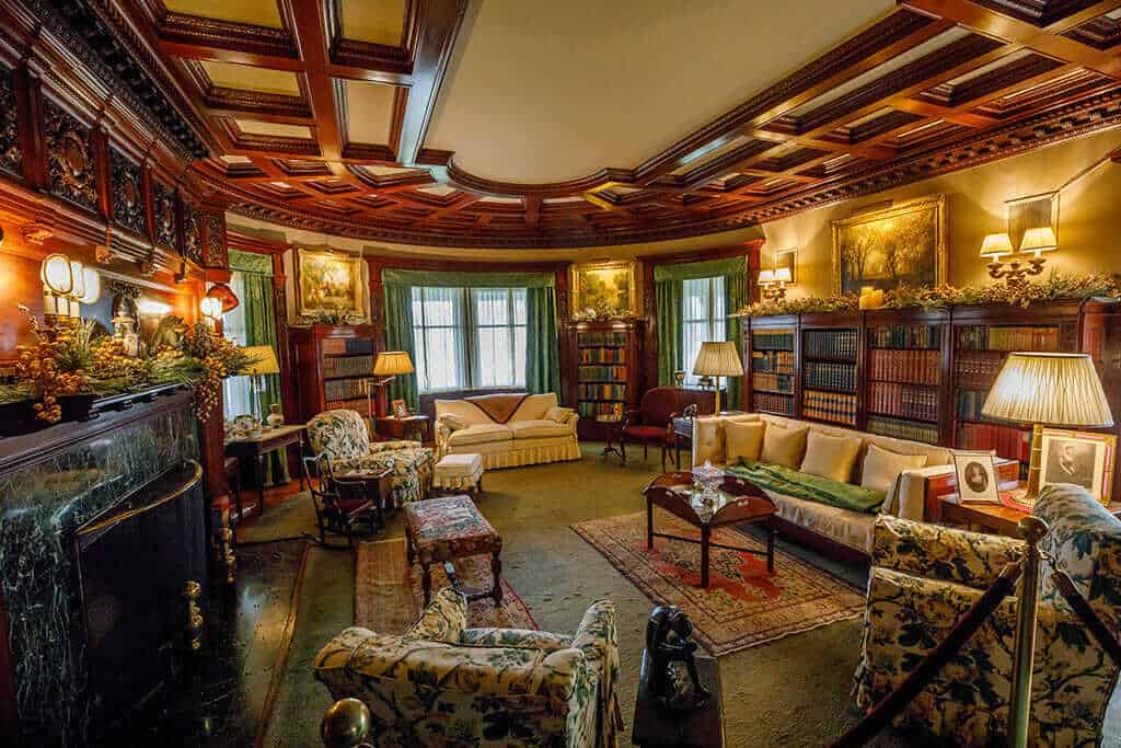 photo credit Peter Ringenberg1024 Ornate historical living room with vintage furniture and wood paneling.