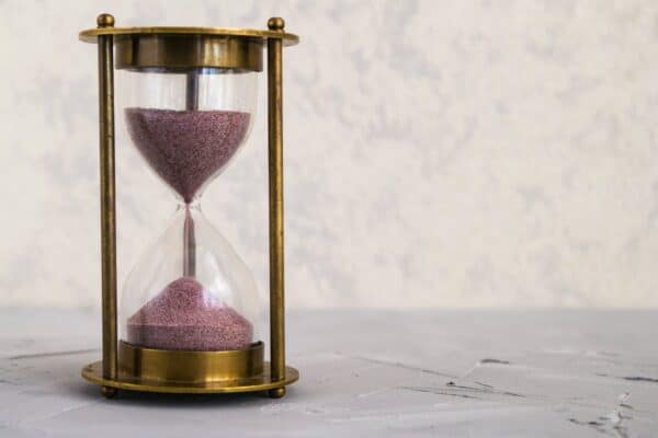 clear hour glass on golden frame