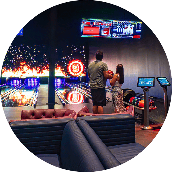 Modern bowling alley with vibrant lighting and digital scoreboards at Albatross.