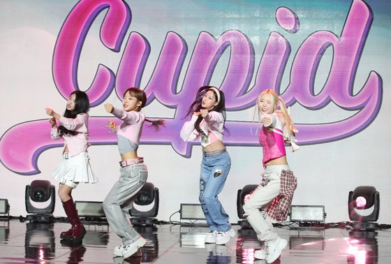Fifty Fifty perform the song ″Cupid″ (2023) at a press conference in Seoul as a group in April 2023.