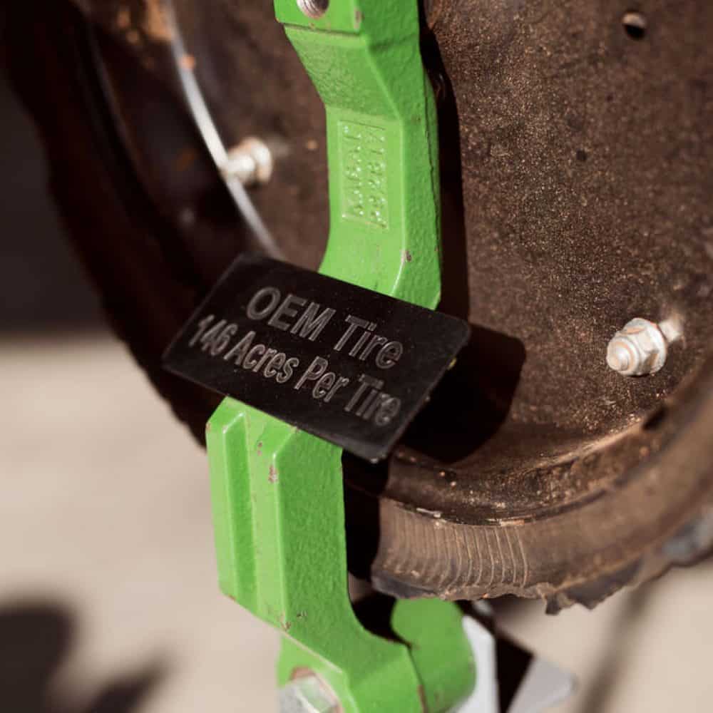 Close-up of an OEM tire showing visible signs of wear and deterioration, highlighting cracks and damage caused by long-term use.