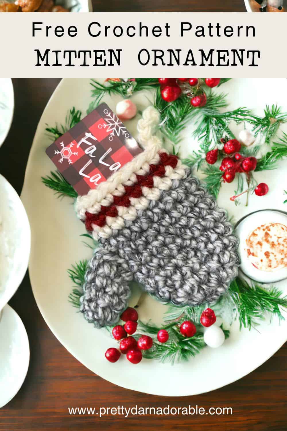 grey crochet mitten hanging on a christmas tree