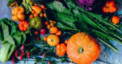 Fresh vegetables laid out on a blue tabletop