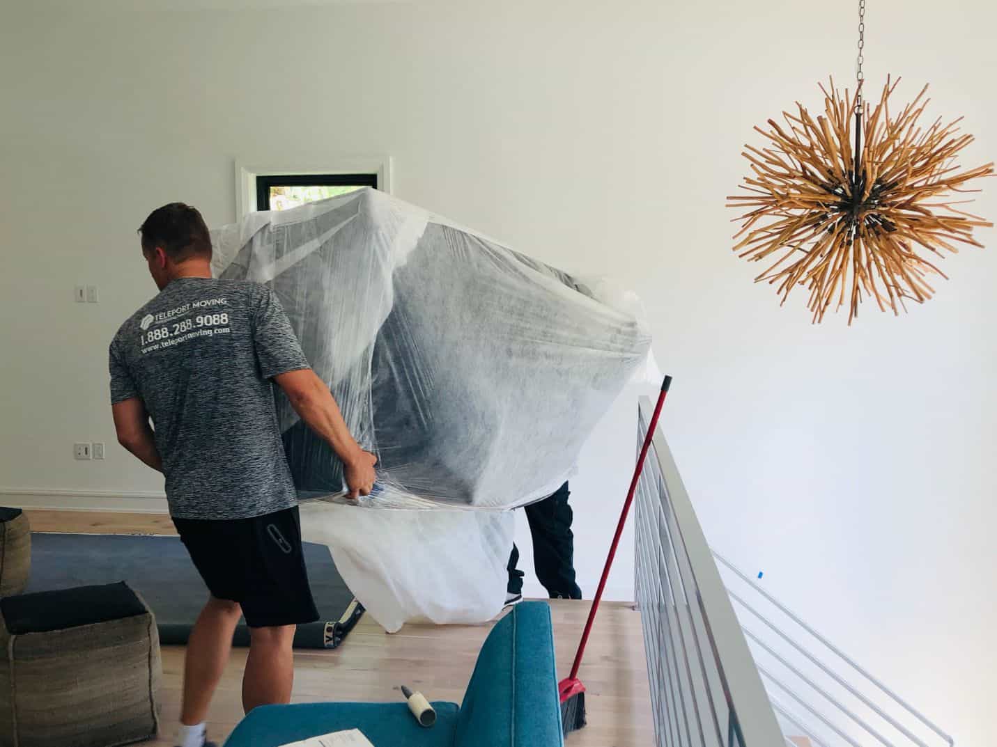 Teleport Moving packing a couch down the stairs.