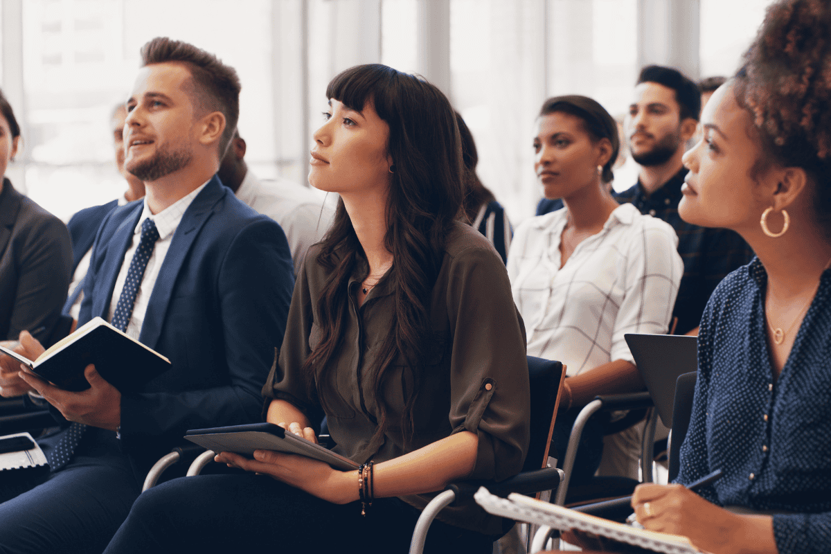 group of employees listening to a speaker