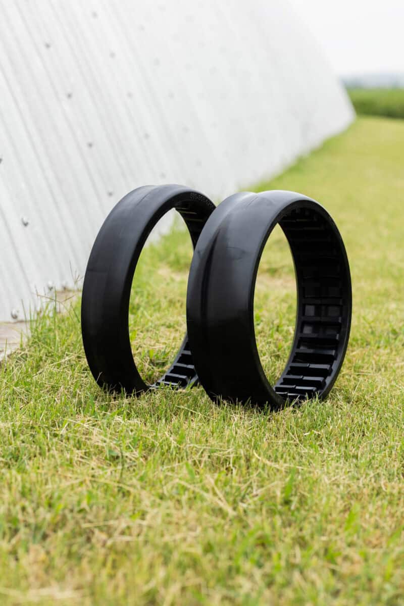 Pair of planter gauge wheels shown side by side on grass.