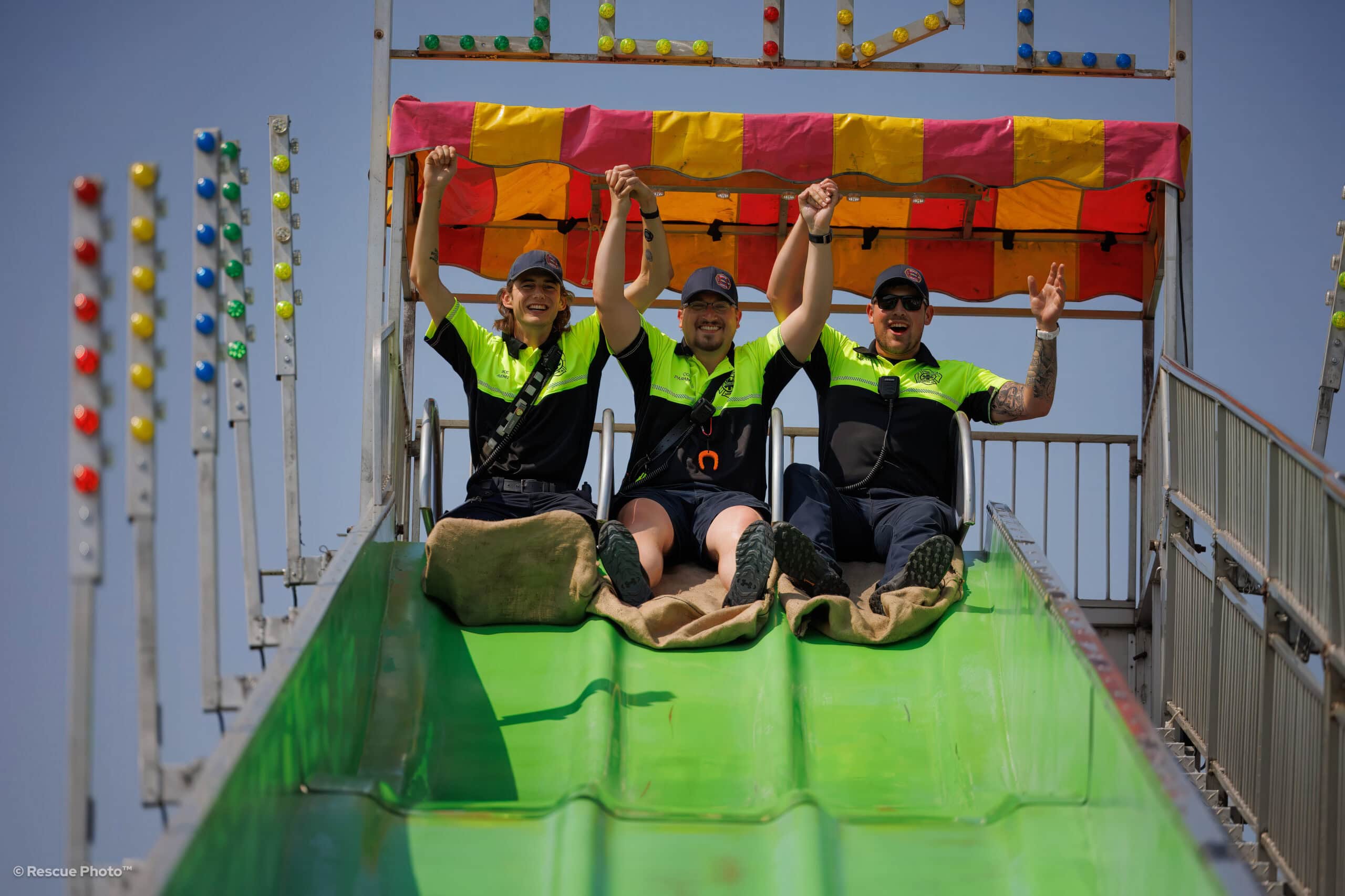 DGEMS Staff at the top of a slide during a festival.