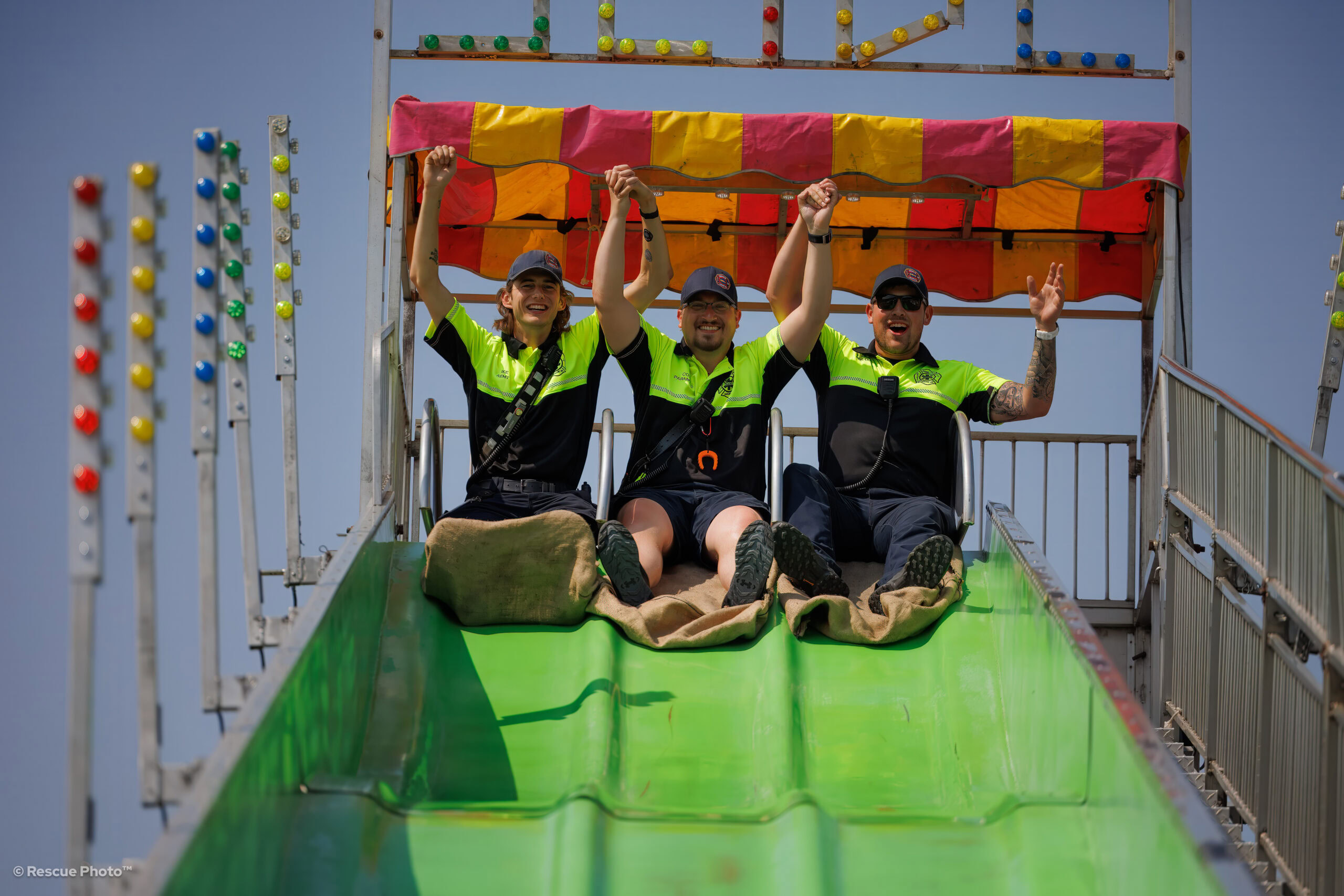DGEMS Staff at the top of a slide during a festival.