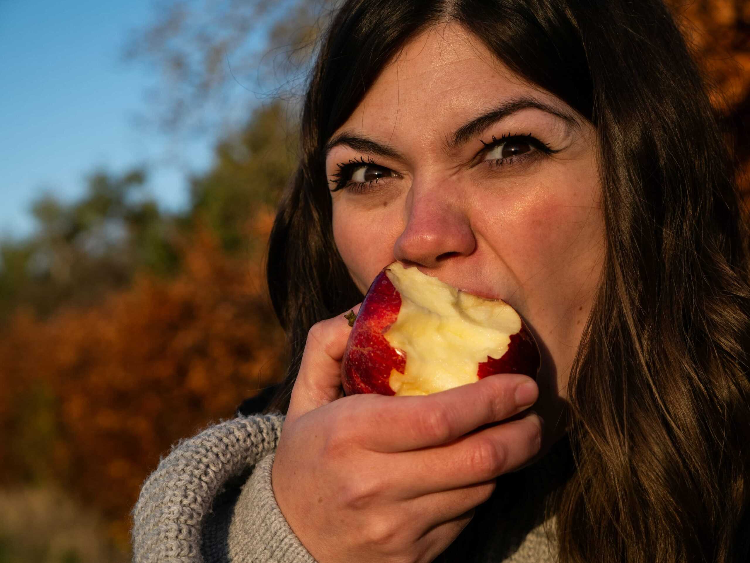 woman biting apple