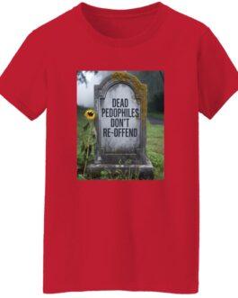 A red women's graphic tee with a tombstone design featuring the text "Dead Pedophiles Don't Re-Offend". A sunflower stands beside the moss-covered tombstone in a graveyard setting.