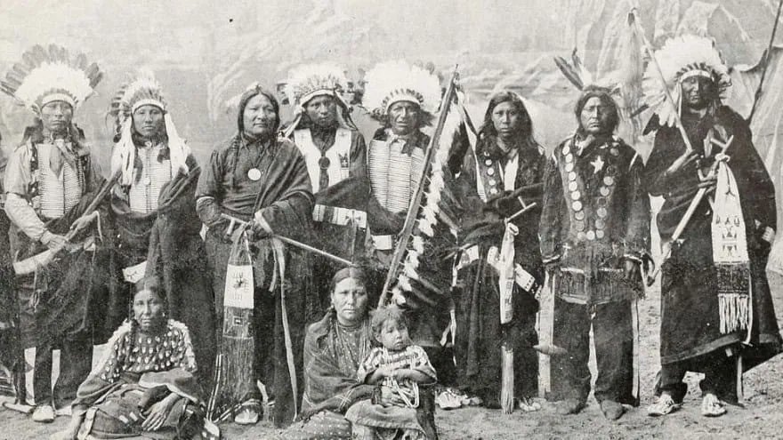 The Potawatomi Tribe Native American leaders in traditional attire at a historical cultural event.