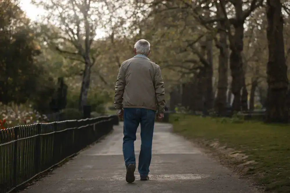 Man taking a stroll in a park while under surveillance | Titan Investigations