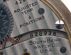sbwatch1 Mechanical watch movement close-up with gears and dials at The History Museum.