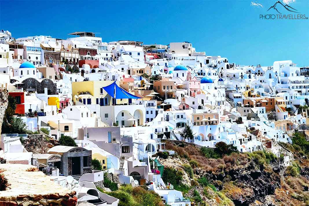 Das berühmte Dorf Oia windet sich mit seinen engen Gassen, Häusern und Kapellen an die Felsen