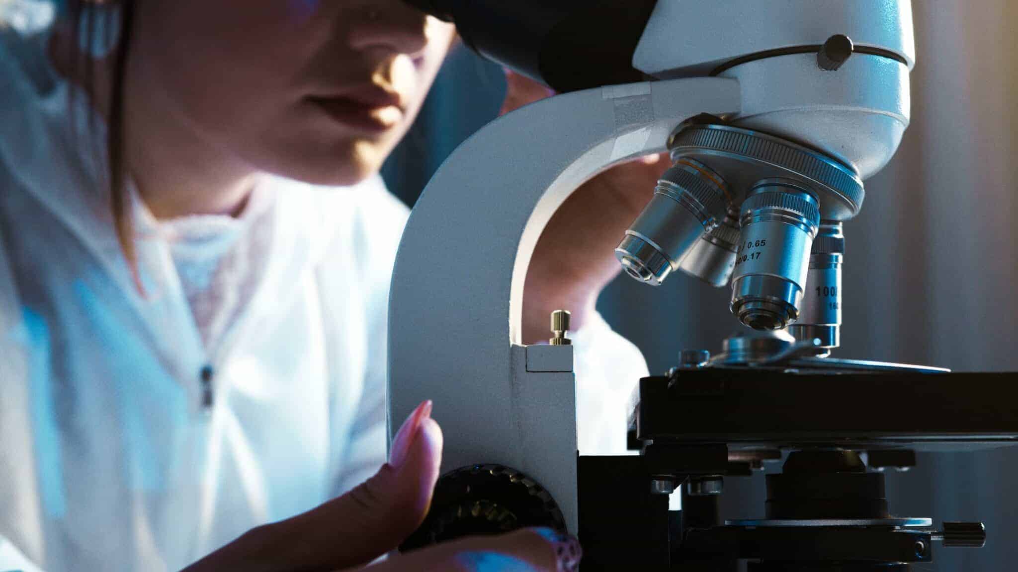 Laboratory scientist examining a sample through a microscope. sexual sadism disorder