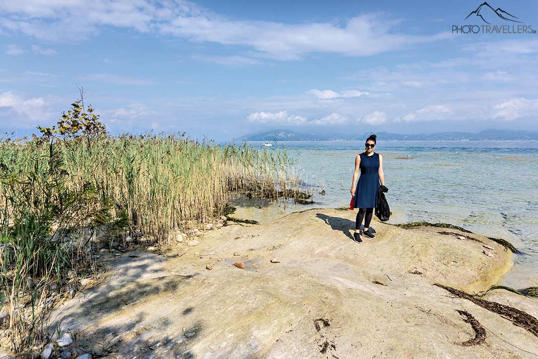 Reisebloggerin Biggi Bauer am Felsstrand in Sirmione am Gardasee, den man so ganz kostenlos erleben kann