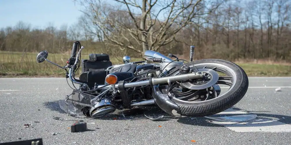a damaged motorcycle on its side after an accident