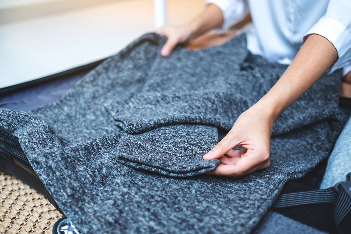 how to pack sweaters in a suitcase