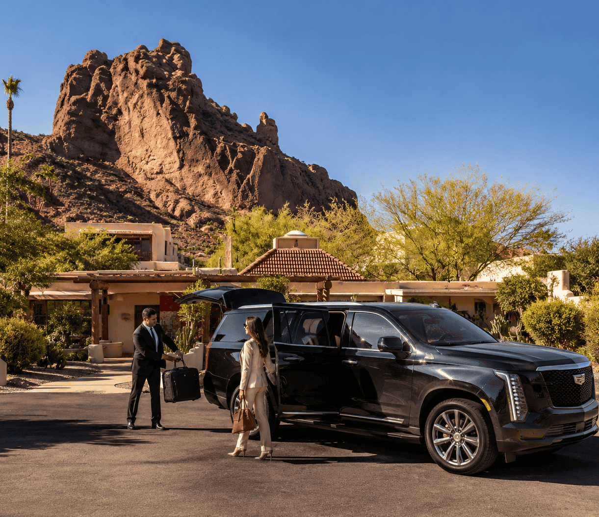 Luxury Chauffeur Service in Paradise Valley Luxury chauffeur service in Paradise Valley with Cadillac Escalade at a luxury estate near Camelback Mountain