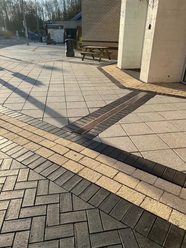 Jet washing patio with outdoor furniture moved aside