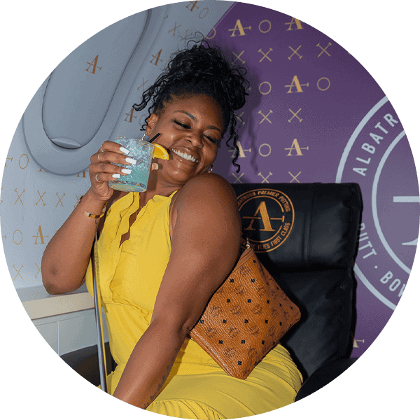 Woman enjoying a refreshing drink during a putting practice session at Albatross.