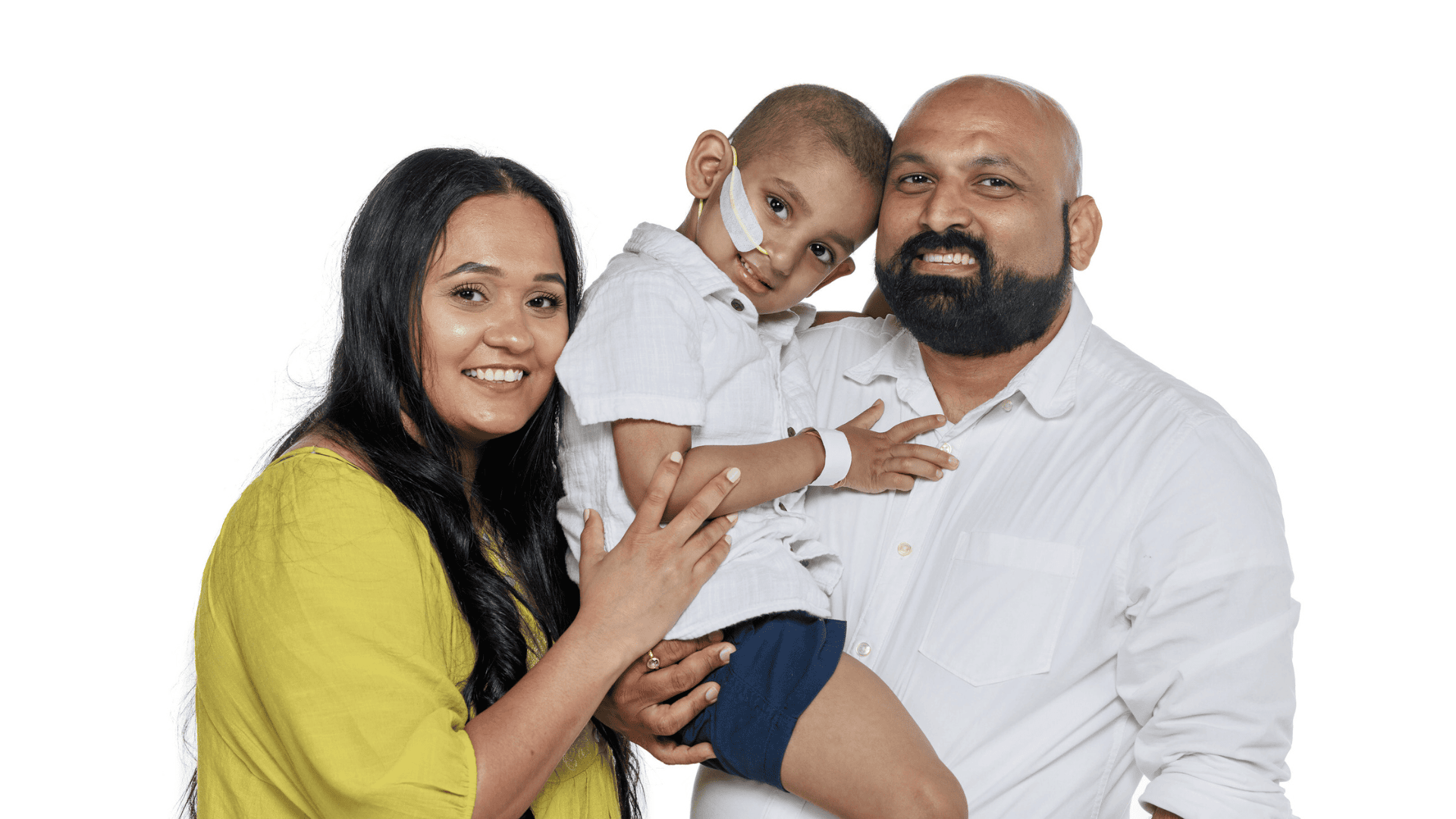 Domino’s Delivers Hope: Franchise Network Joins Forces Again for St. Jude family portrait shows a young child currently undergoing treatment at St. Jude Children’s Research Hospital, held by his father while his mother embraces them both.