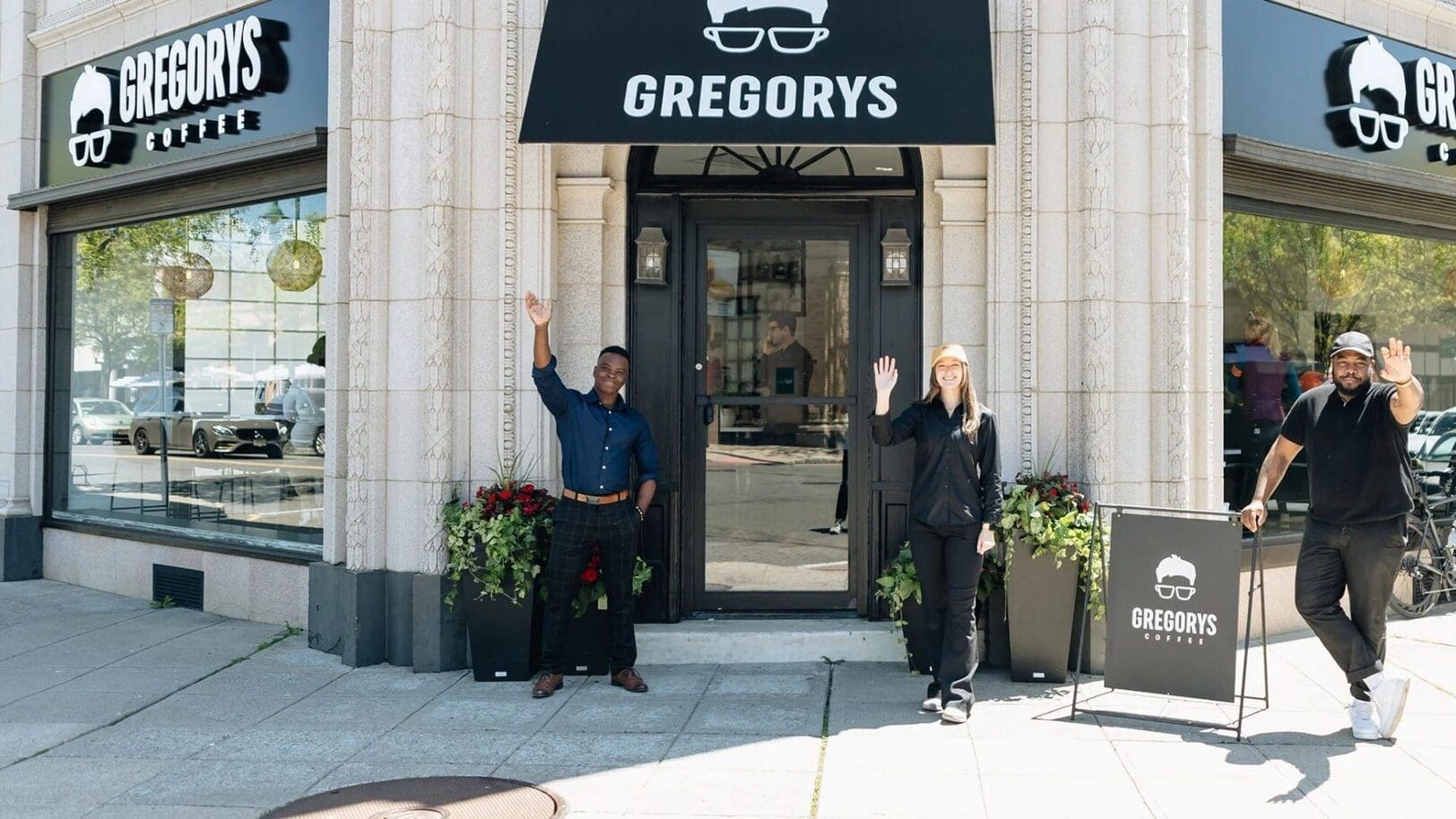 Team members stand outside a Gregorys Coffee location, welcoming guests at the storefront. Image Courtesy of Gregorys Coffee