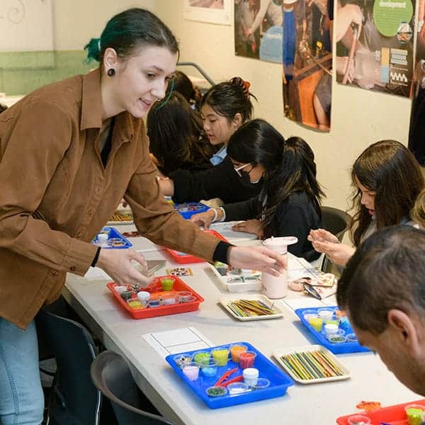Fused glass instructor with youth at Pittsburgh Glass Center
