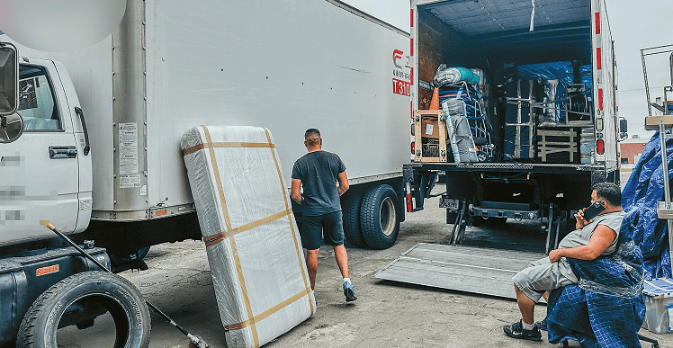 Truck drivers resting in a Gardena parking lot amid declining freight volume from U.S. tariff impact