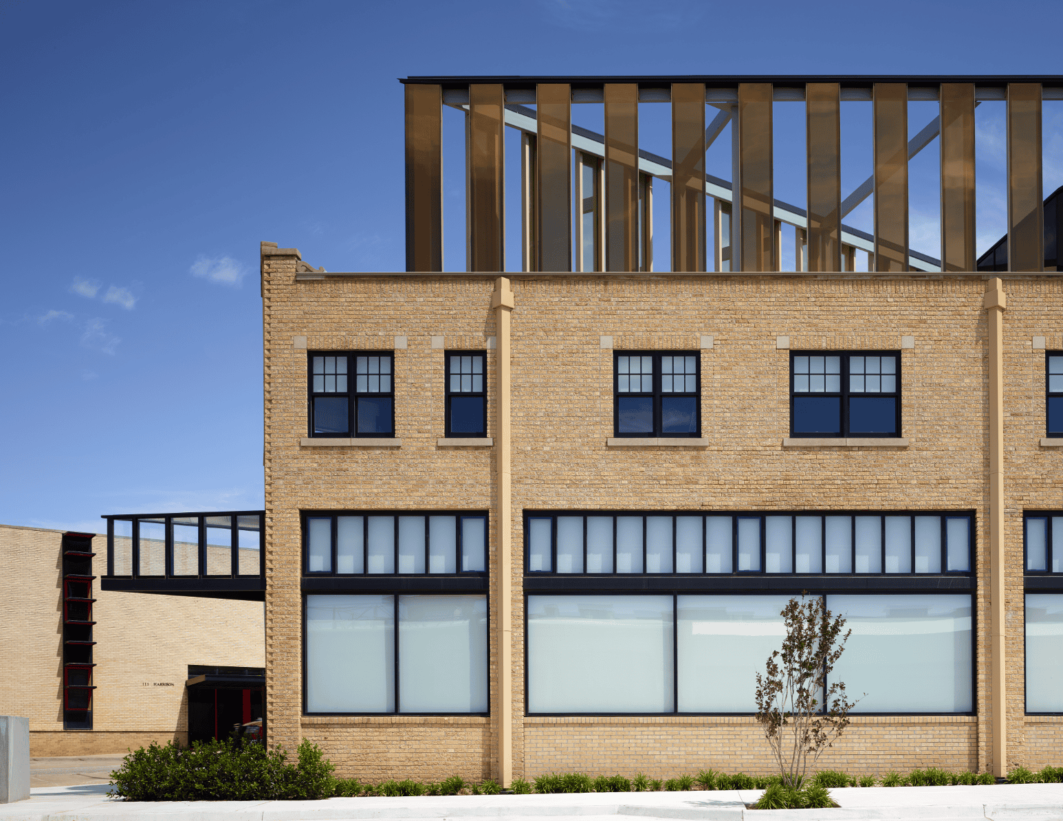 PLICO at the Flatiron façade with modern glass rooftop addition