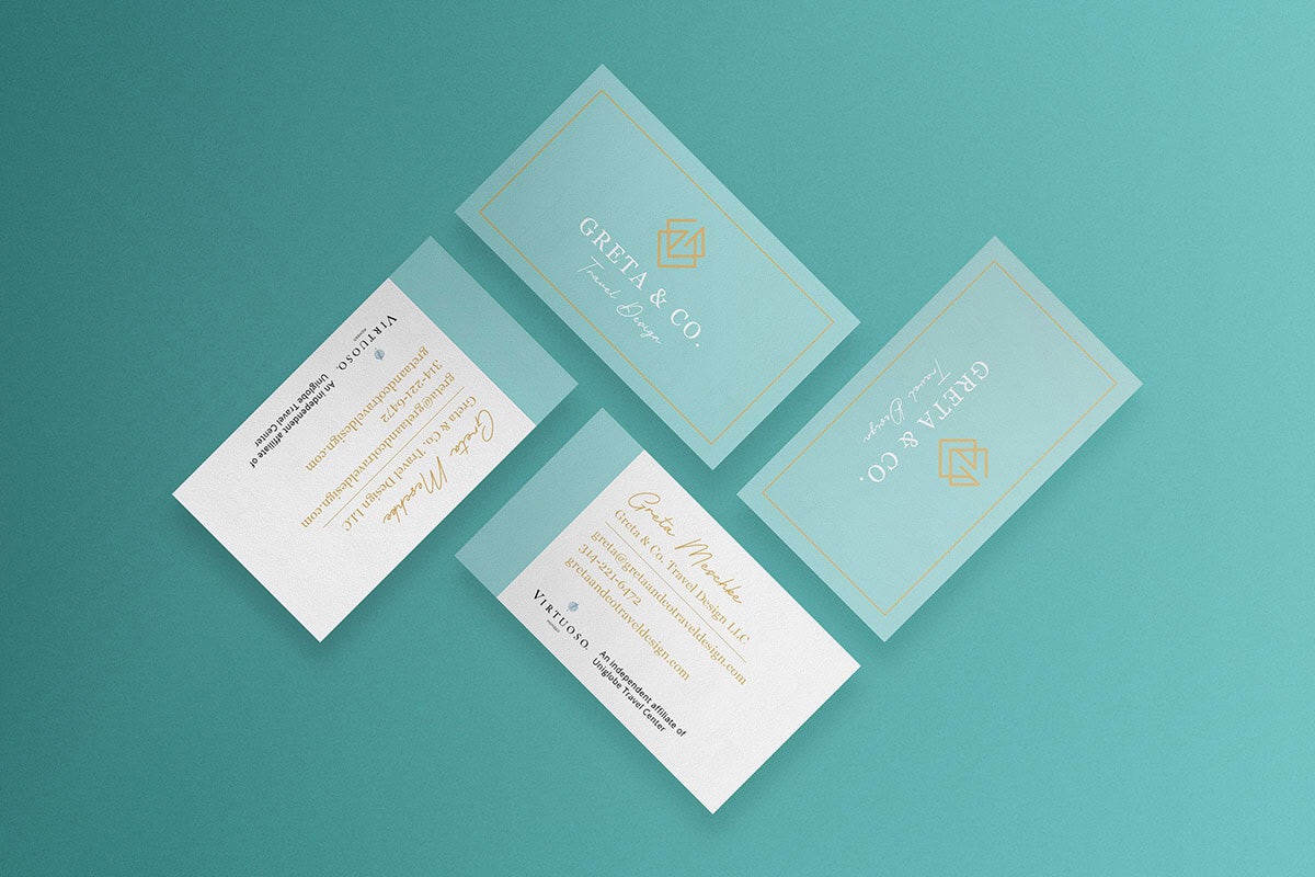 A set of branded business cards designed by a marketing agency, displayed on a teal background.